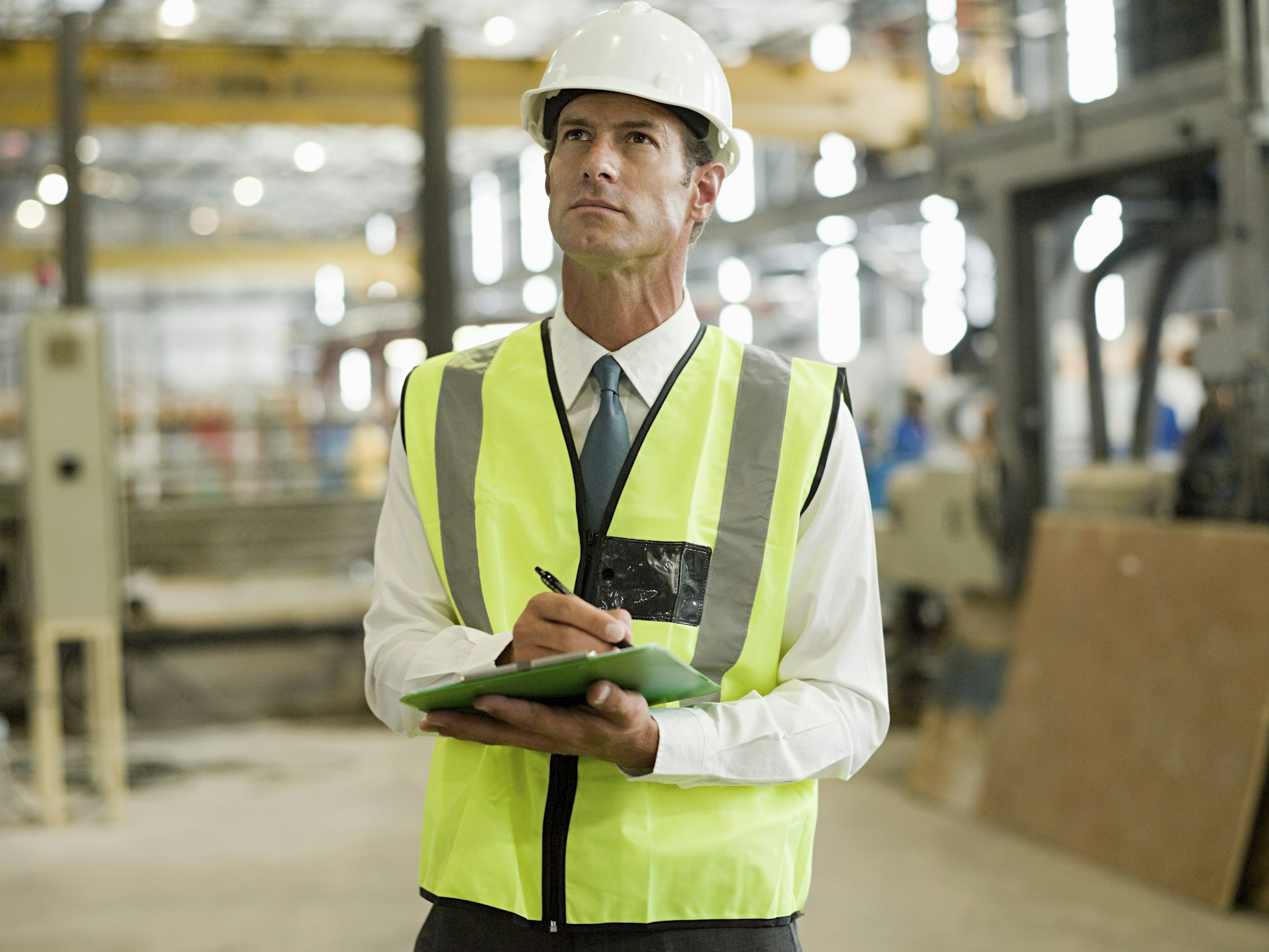 Construction manager overseeing a factory floor.