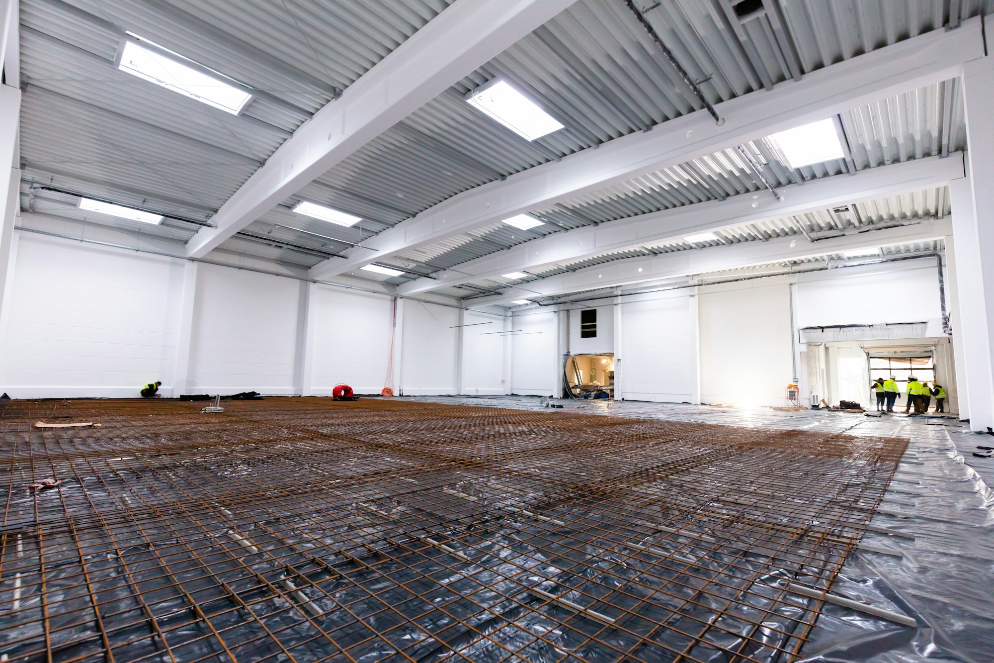 Floor concrete reinforcement at warehouse construction site.